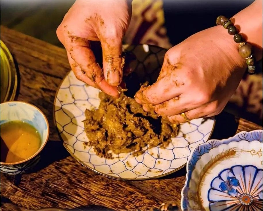 Handcrafted traditional Chinese incense beads being shaped by hand using botanical powders and natural binders